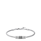 Silver-toned steel snake chain bracelet with three black enamel cylindrical beads and two silver-toned ribbed beads.