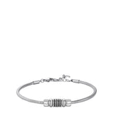 Silver-toned steel snake chain bracelet with a central ribbed cylindrical element and a lobster clasp closure.