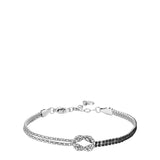 Men's steel bracelet with a central knot, half adorned with clear zircons and half with black zircons, featuring a lobster cl