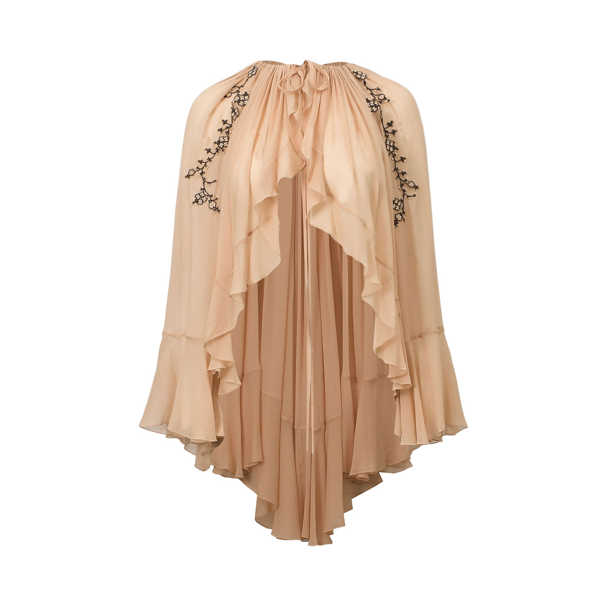 Powder-colored flowing dress with a drawstring neckline, cascading ruffles, and black floral embroidery.