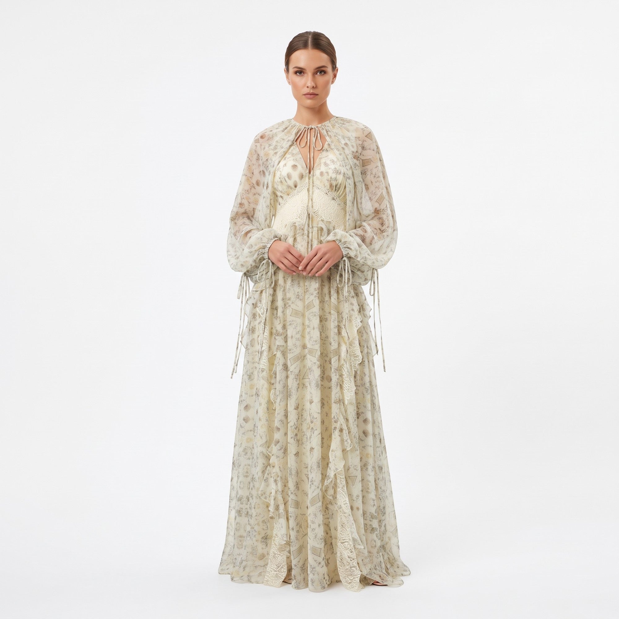 Cream floral maxi dress with sheer long sleeves, tie-neck, V-neck lace-trimmed bodice, and a flowing skirt with vertical ruff