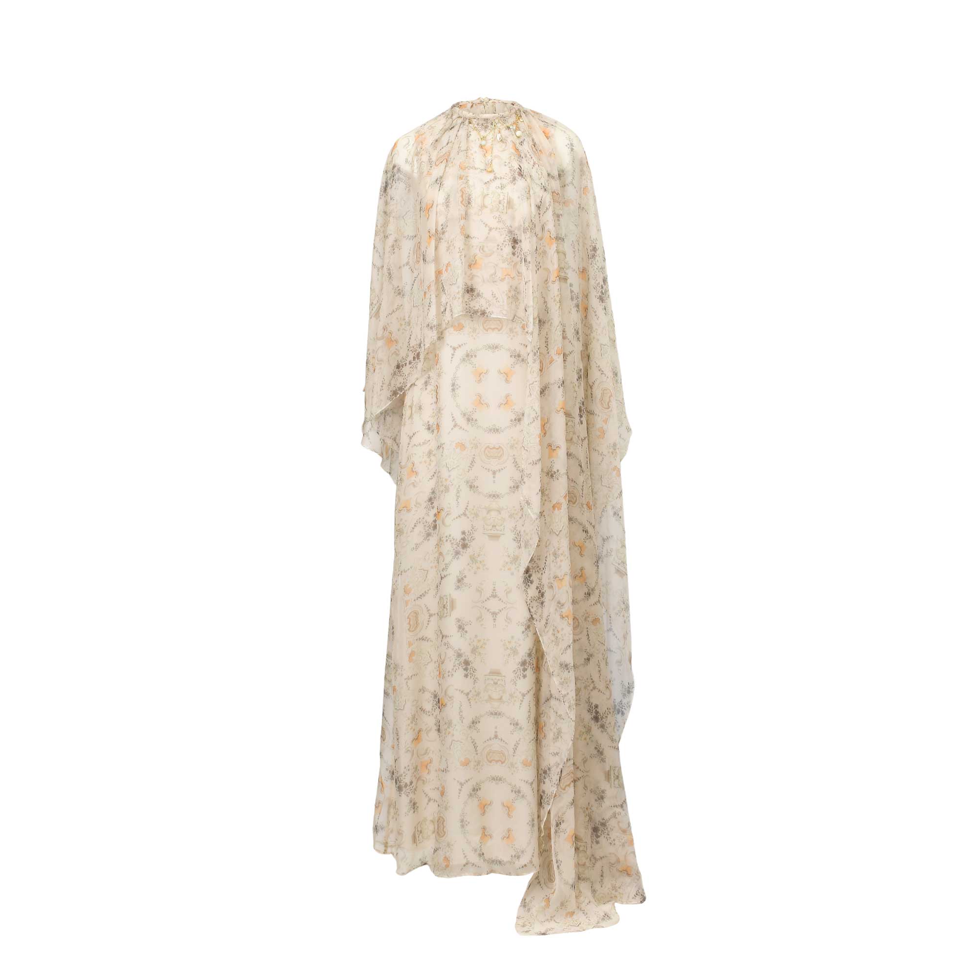 Orange and grey patterned sheer maxi dress with a high ruffled neckline and a flowing cape overlay.