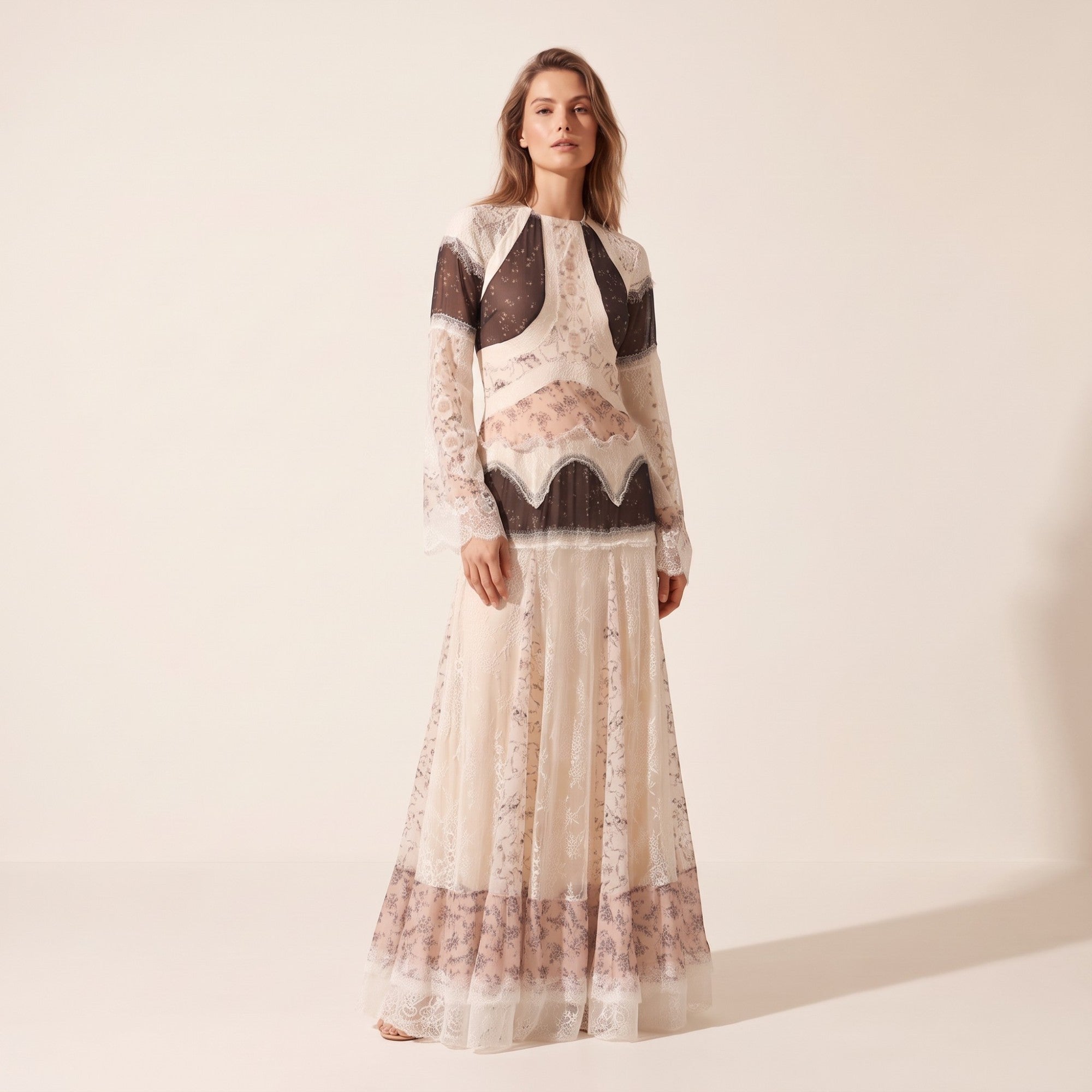 Cream lace maxi dress with high neck, long flared sleeves. Bodice has dark brown sheer panels and white lace trim. Skirt feat