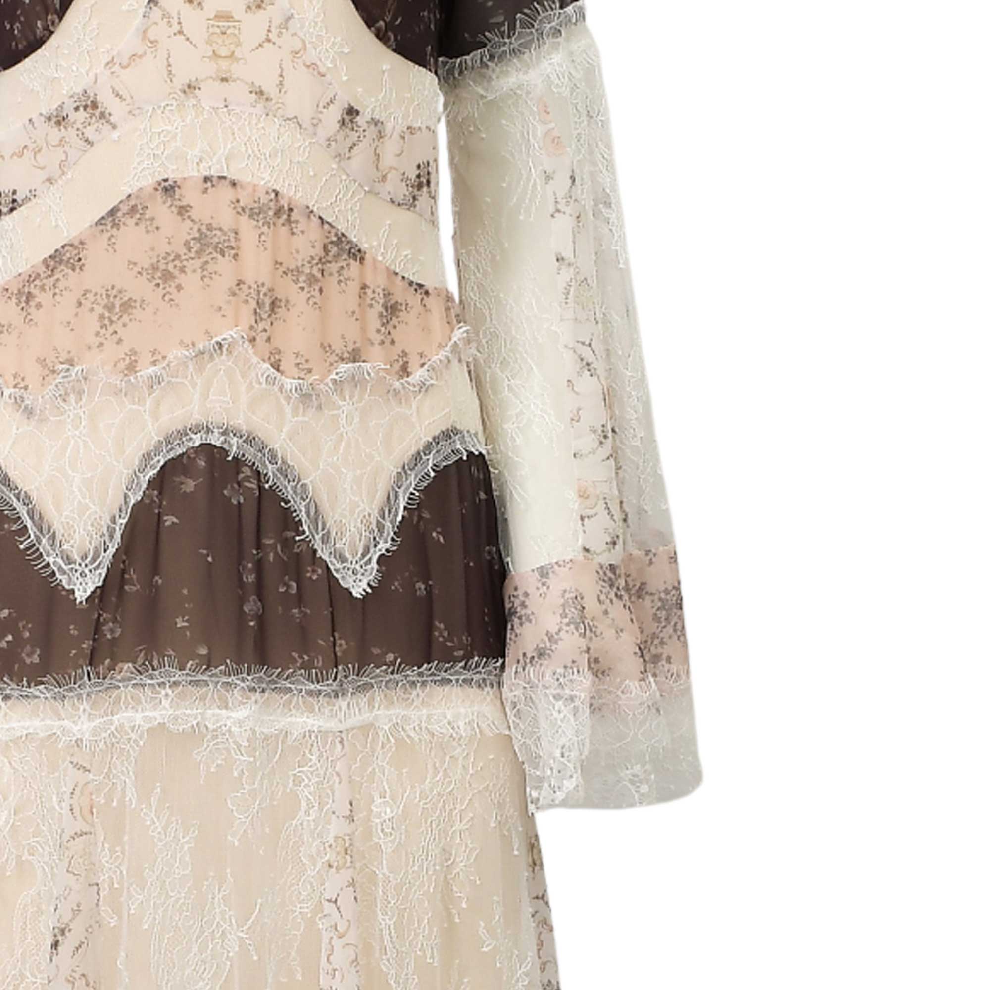 Beige, pink, and brown floral dress with sheer tiered panels and wavy cream lace trim. Long sleeves with matching floral and