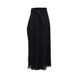 BAQA designer black maxi skirt with a high-waisted structured belt, silver buckle, and flowing pleated fabric.