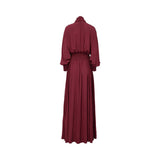 Front view of a BAQA burgundy maxi dress featuring a tie-neck scarf detail, long sleeves with smocked cuffs, and a wide smocked waistband on a white background.