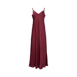 Front view of a BAQA burgundy maxi dress featuring a tie-neck scarf detail, long sleeves with smocked cuffs, and a wide smocked waistband on a white background.