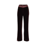Front view of BAQA burgundy velvet trousers showing the contrast satin waistband and tailored straight leg.
