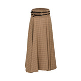 BAQA camel-colored maxi skirt with a black windowpane check pattern, featuring a high-waisted fit and two decorative dark brown belts with gold buckles.