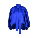 BAQA royal blue satin cape-style top featuring voluminous draped sleeves and a flowing tie-neck design.
