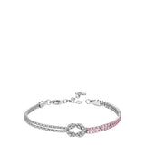 Silver-toned steel bracelet with a central knot, one side adorned with clear zircons and the other with pink zircons.