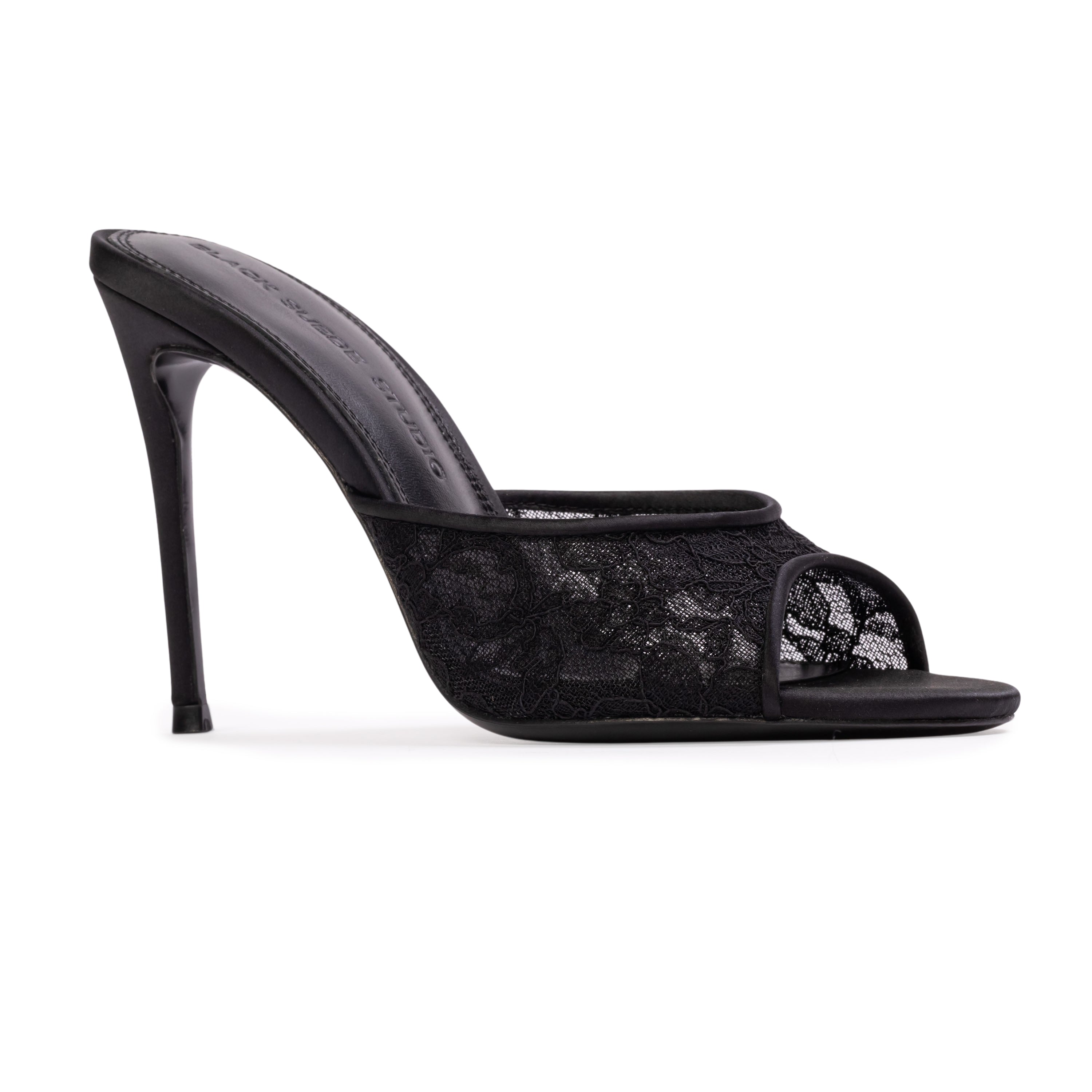 BLACK SUEDE STUDIO Geni 100 black lace open toe stiletto mule shown from a three-quarter inner profile view.
