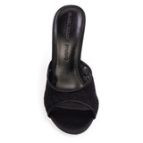 A high-angle, top-down shot looking directly into the footbed of the mule, displaying the debossed "BLACK SUEDE STUDIO" logo on the black leather insole and the curved peep-toe opening.
