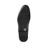 Bottom view of the Baldinini shoe outsole showing the sleek black dress sole with a grooved non-slip front pad, centered brand name engraving, and a debossed logo on the heel cap against a white background.