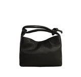 Piumelli Bonbon Black mini top-handle bag in textured leather with knot detail and gold branding.