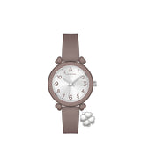Taupe watch with a silver-toned face, black numerals, and heart-shaped lugs. A silver-toned four-leaf clover charm hangs from