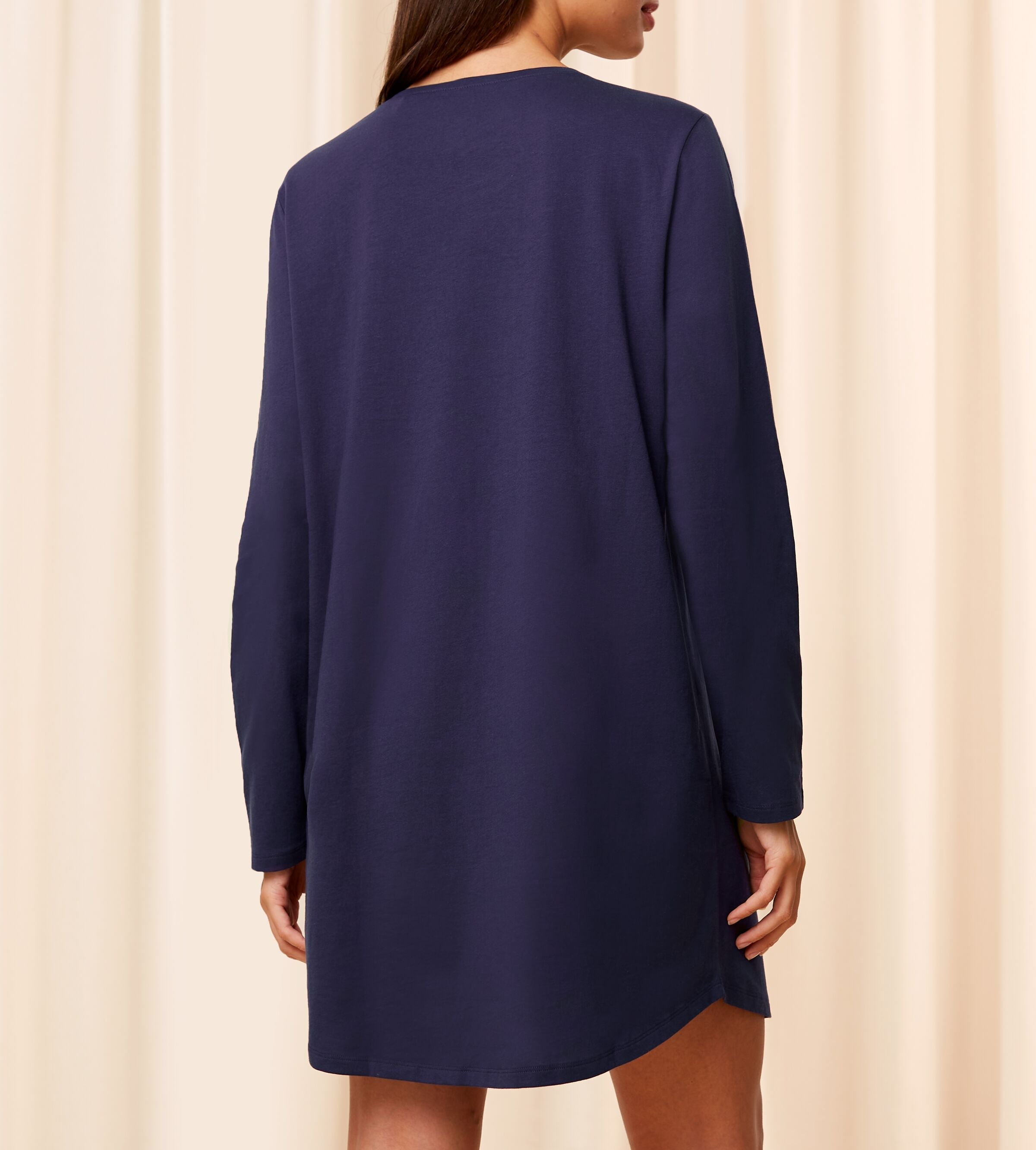 Back view of Model wearing the Triumph navy long sleeve nightdress, showing the relaxed silhouette and elegant long sleeves. Shop Now Online