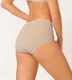 Back view of model wearing the Sloggi Basic+ beige maxi panties, showcasing the high-waisted silhouette and soft cotton texture. Shop Now Online