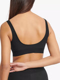 Back view of model wearing the Sloggi Ever Ease black bra top, showing the wide shoulder straps and seamless, wire-free design. Available Now Online