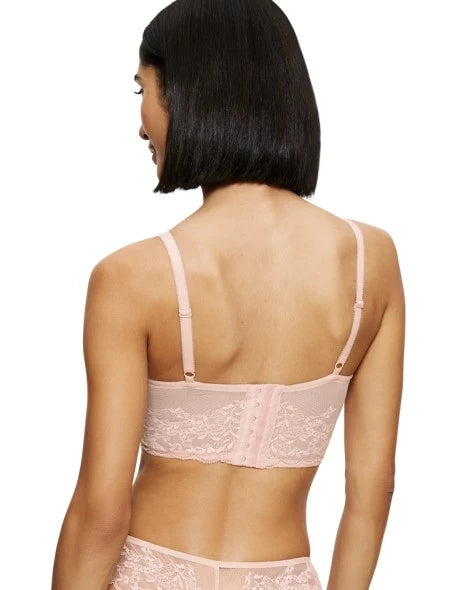 Back view of model wearing the Triumph Sensual Spotlight light pink corset, showcasing the intricate lace panels and the adjustable straps with back closure. Now Available Online