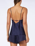 Back view of model wearing the Triumph Silky Sensuality navy pajama set, showcasing the lace-trimmed top and the shimmering, fluid fabric. Shop Online Today