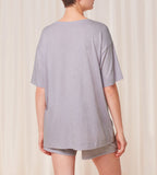 Back view of model wearing the Triumph light purple pajama set, highlighting the soft-touch fabric and comfortable drawstring trousers. Order Online Today