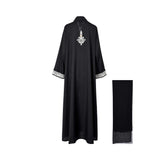 Back view of the Nero women's black embroidered abaya with ivory detailing and matching scarf. Shop the Latest Collection