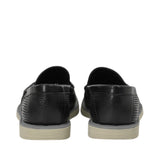 Rear view of a pair of Baldinini black loafers showing the pebbled leather heel counter, smooth top-line trim, and the layered edge of the comfortable beige rubber sole against a white background.