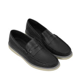 An overhead three-quarter perspective of a pair of Baldinini black perforated loafers, detailing the leather texture and the small metallic B logo on the outer corner of the penny strap against a white background.