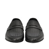 Front-facing view of a pair of Baldinini black loafers showcasing the rich woven leather pattern across the toe boxes and the matching smooth leather crossover saddle straps against a white background.