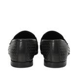 Rear view of a pair of Baldinini black woven loafers highlighting the vertical heel seam construction, clean top-line leather piping, and the low-profile black rubber outsoles against a white background.