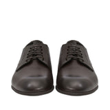Front-facing view of a pair of Baldinini dark brown Derby shoes highlighting the clean almond toe boxes and symmetrical four-eyelet lace-up design against a white background.