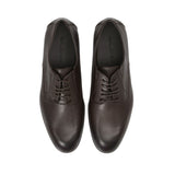 Direct top-down view of a pair of Baldinini Derby shoes, showing the dark brown insoles stamped with the black Baldinini brand name framed by the structured leather uppers against a white background.