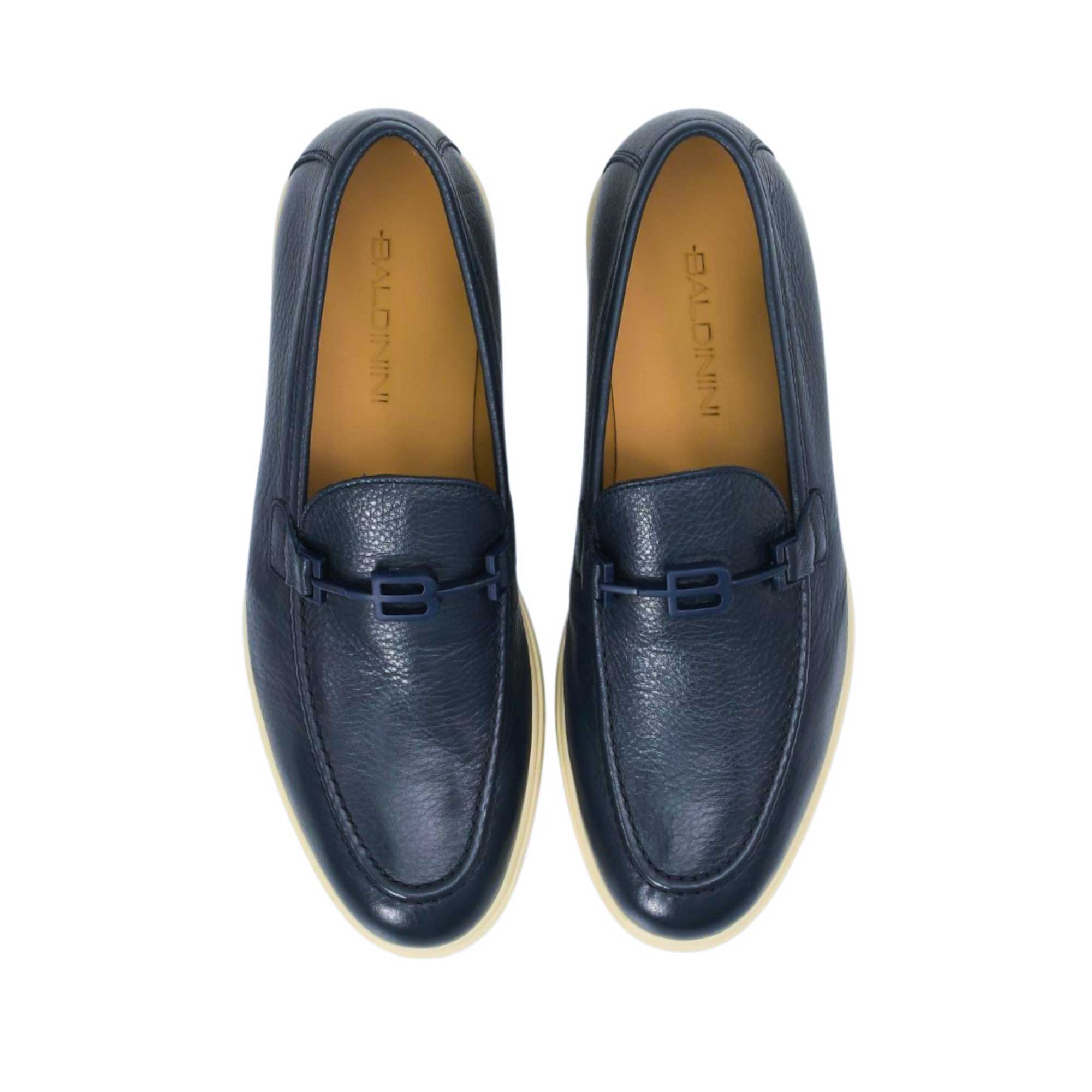 Direct top-down view of a pair of Baldinini loafers, showcasing the rich tan leather insoles debossed with the brand name and the streamlined silhouette of the navy grained uppers against a white background.