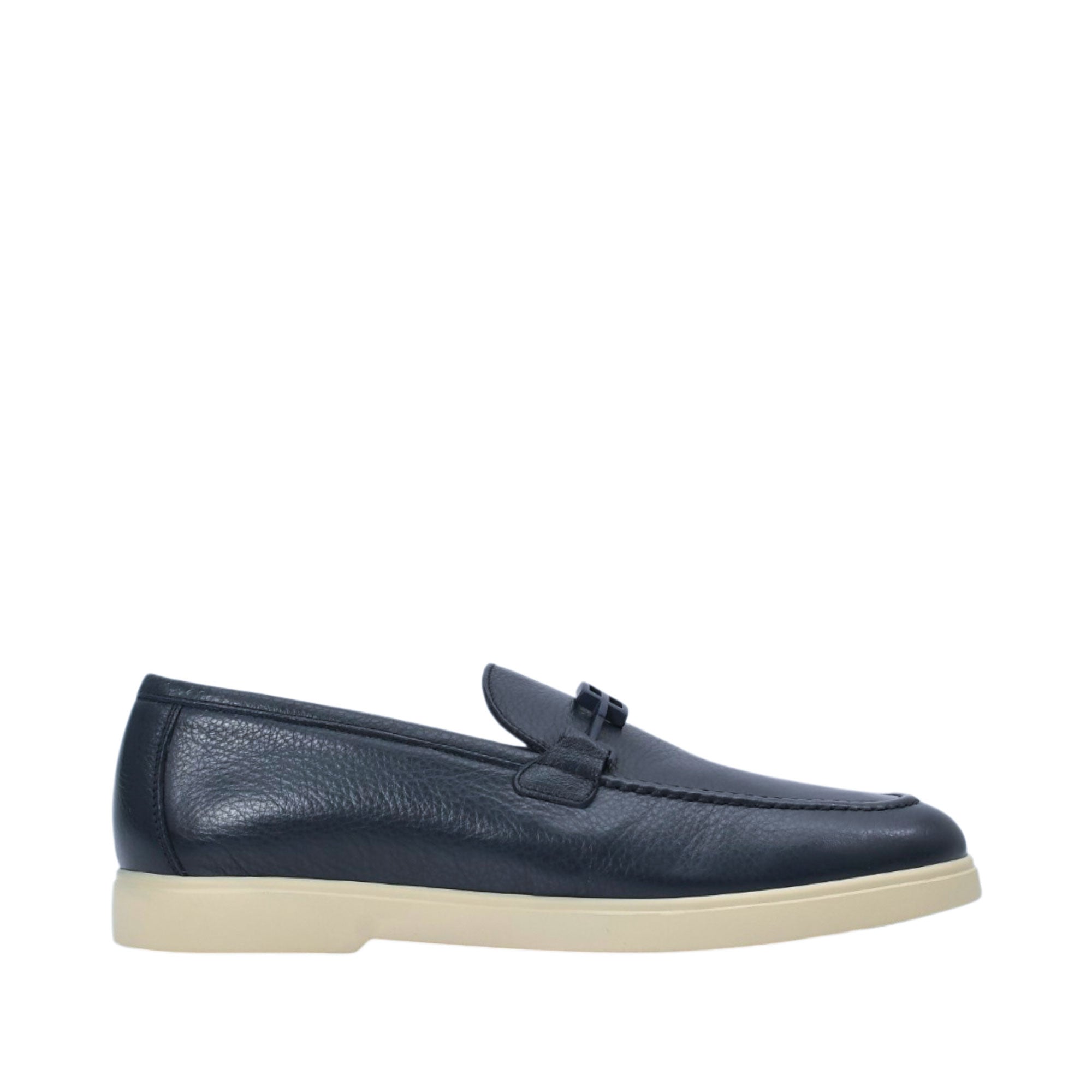 Profile view of a Baldinini navy blue grained leather driving loafer, highlighting its raised moc-toe stitching, matte bridge strap accent, and contrast beige rubber sole against a white background.
