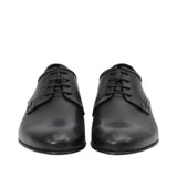 Front-facing view of a pair of Baldinini black dress shoes showcasing the smooth almond toe caps and the neat open-lacing system with thin tonal laces against a white background.