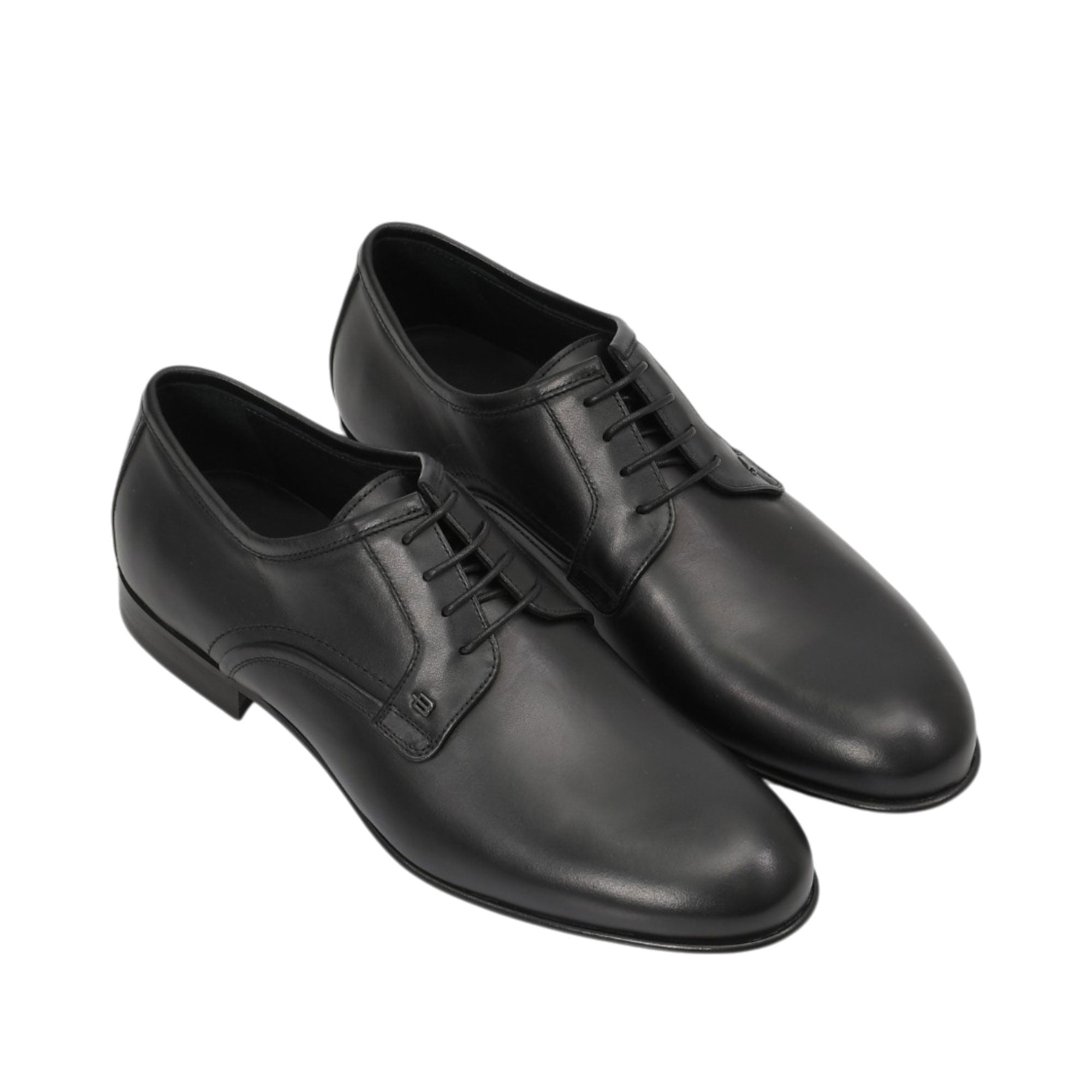 An overhead three-quarter angle view of a pair of Baldinini black leather dress shoes, showcasing their polished sheen and minimalist professional aesthetic against a white background.