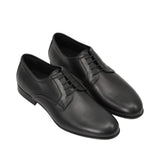 An overhead three-quarter angle view of a pair of Baldinini black leather dress shoes, showcasing their polished sheen and minimalist professional aesthetic against a white background.