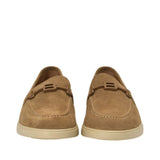 Front-facing view of a pair of Baldinini tan suede loafers showcasing the contrast cream topstitching on the apron toe and the integrated 'B' logo strap across the vamps against a white background.