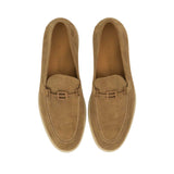 Direct top-down view of a pair of Baldinini loafers showing the tan leather insoles cleanly debossed with the dark Baldinini brand name signature against a white background.