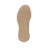 Bottom view of the Baldinini sneaker outsole showcasing the tan-colored flexible rubber base covered in a continuous raised circular stud texture for superior grip against a white background.