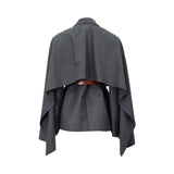 Back view of the BAQA grey blazer showing the dramatic cape-style overlay draped over the shoulders and waist belt.