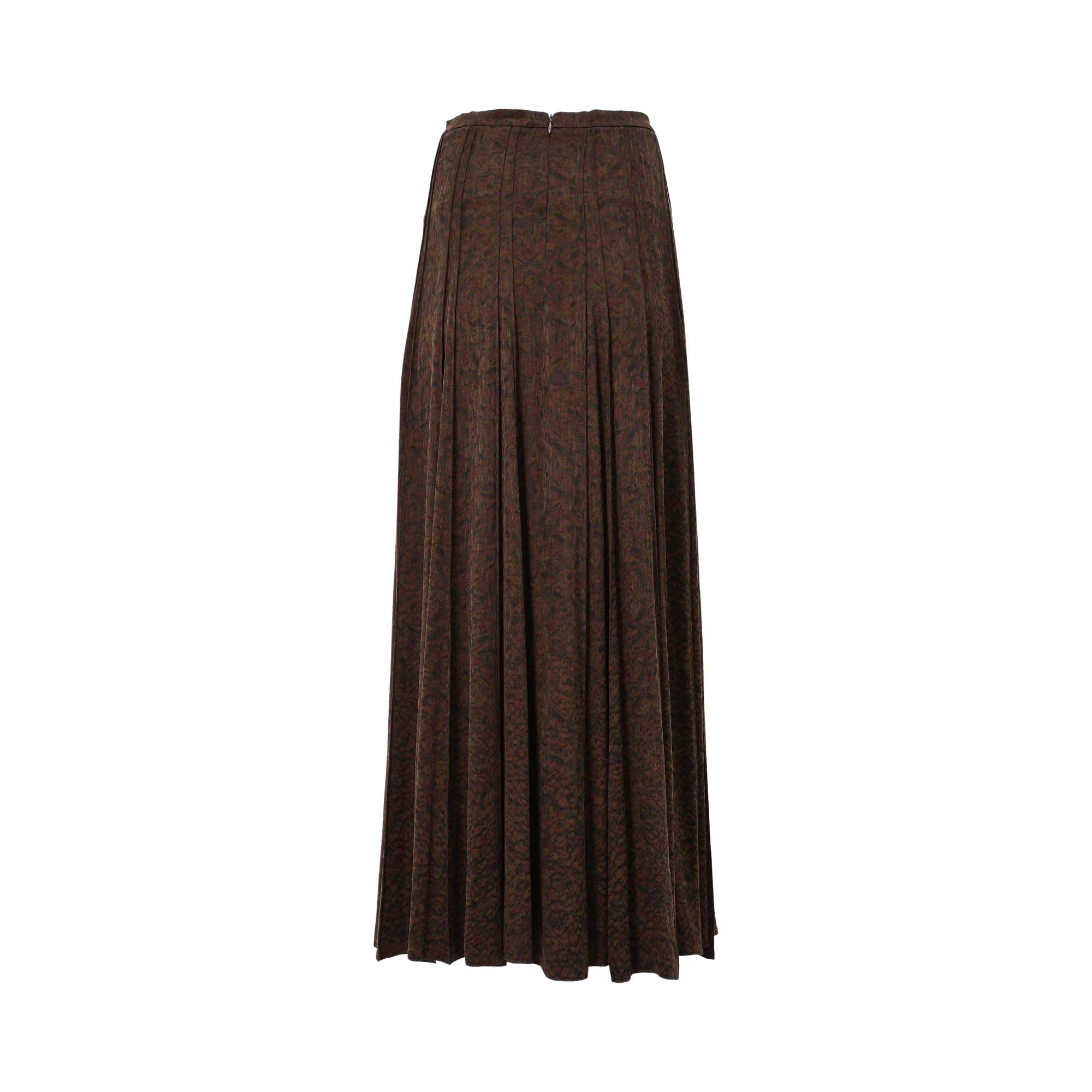 Back view of BAQA pleated maxi skirt showing the concealed zipper closure and intricate brown and green abstract pattern.