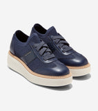 Pair of navy blue knit and leather platform sneakers with flat laces, a textured side panel, and a thick off-white ribbed pla