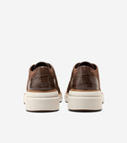 Pair of brown knit oxfords with dark brown crocodile-embossed heel counters, brogue details, and thick off-white platform sol