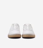 Pair of white leather low-top sneakers with white laces, tan collar lining, and ribbed gum soles.