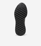 Black sneaker sole with a textured pattern of raised diamonds, each containing a small dot. 'COLE HAAN GRAND 360' is embossed