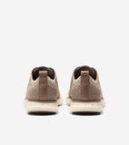 Pair of tan knit oxfords with light brown heel tabs featuring the Cole Haan logo and off-white textured soles.