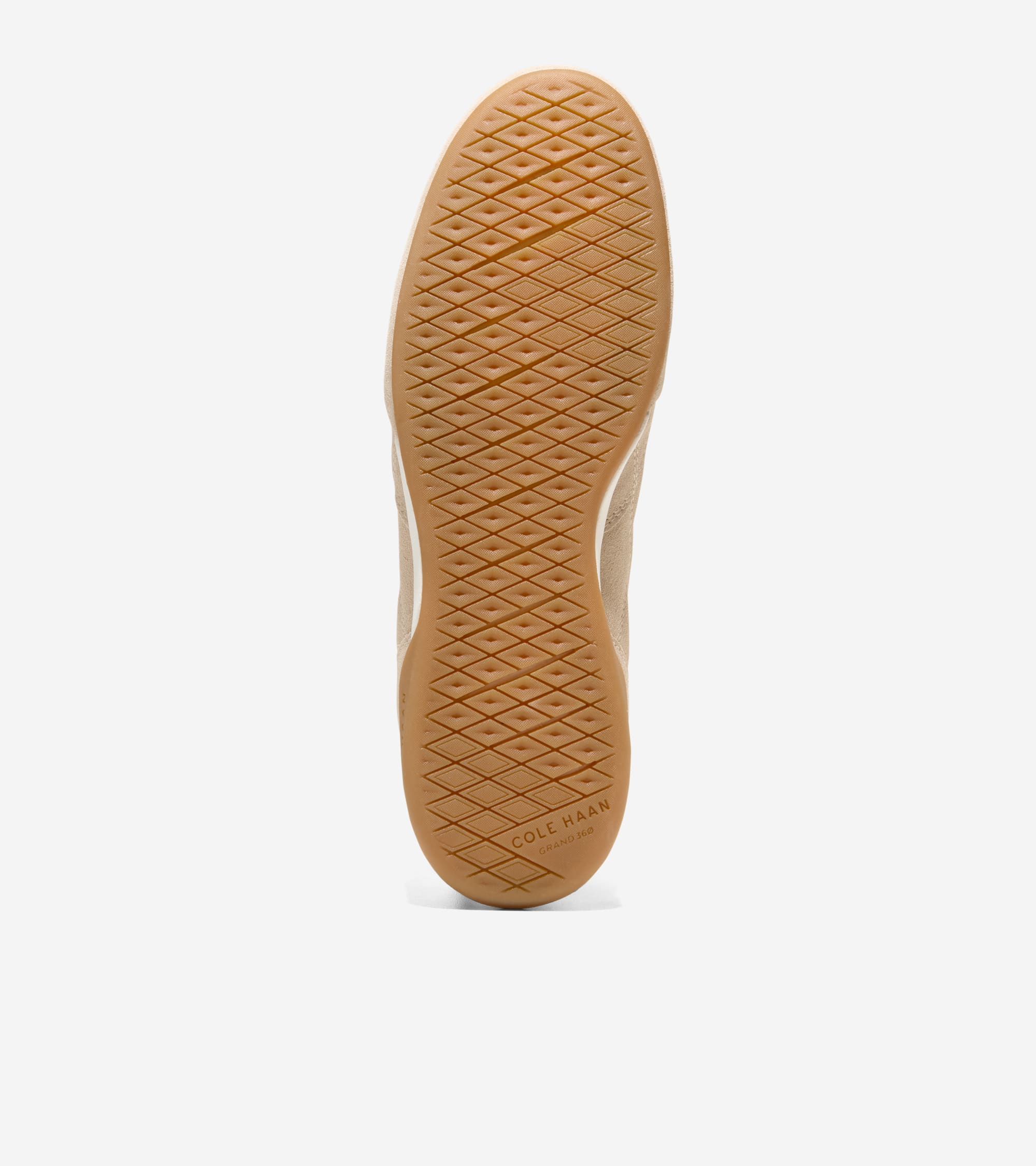 Tan rubber sole of a sneaker with a diamond grid pattern and white trim. 'COLE HAAN GRAND 360' is embossed near the heel.