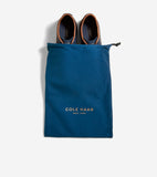 Pair of navy blue low-top sneakers with tan leather trim around the collar and dark brown lining.